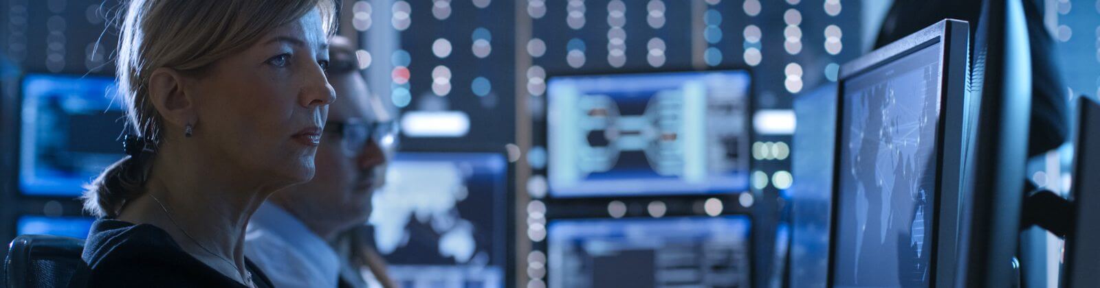 世界地図が表示されたコンピューター画面を見ている女性たち